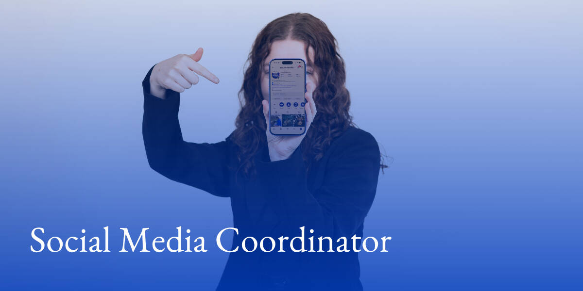 A student holding up a smart phone displaying an Instagram account and text that reads "Social Media Coordinator"